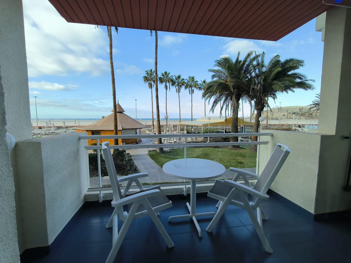 Private balcony overlooking palms and the ocean