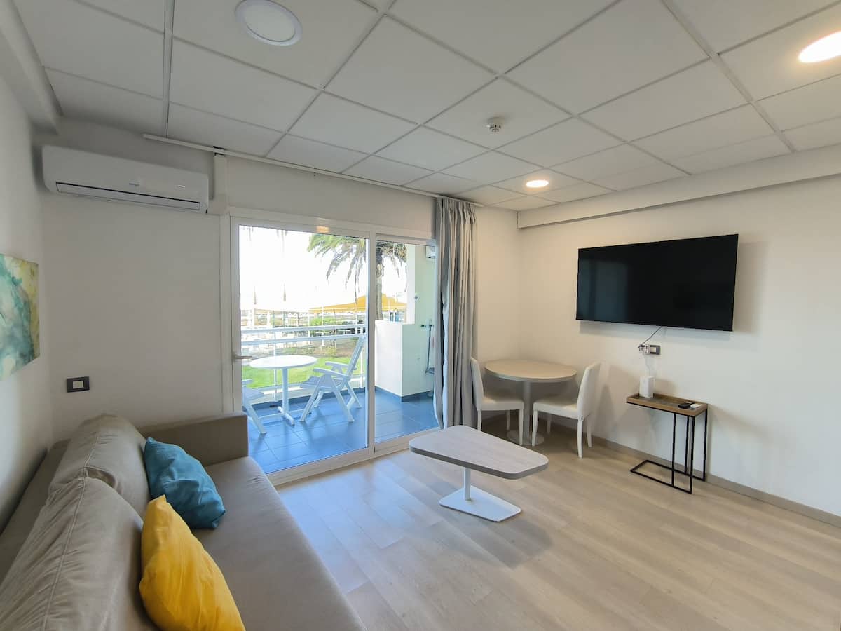 Bright living area with Smart TV and workspace